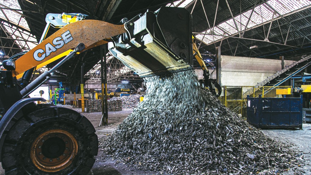 A wheel loader dumps metal scraps out of its bucket