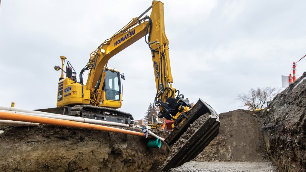 An excavator uses a tiltrotator to rotate its bucket