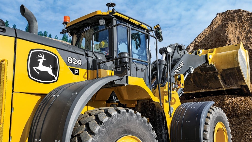 A wheel loader digs into a pile