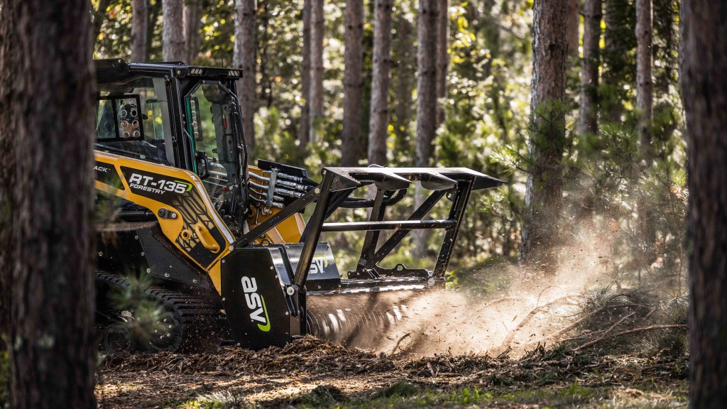 A mulcher mulches up vegetation on a job site