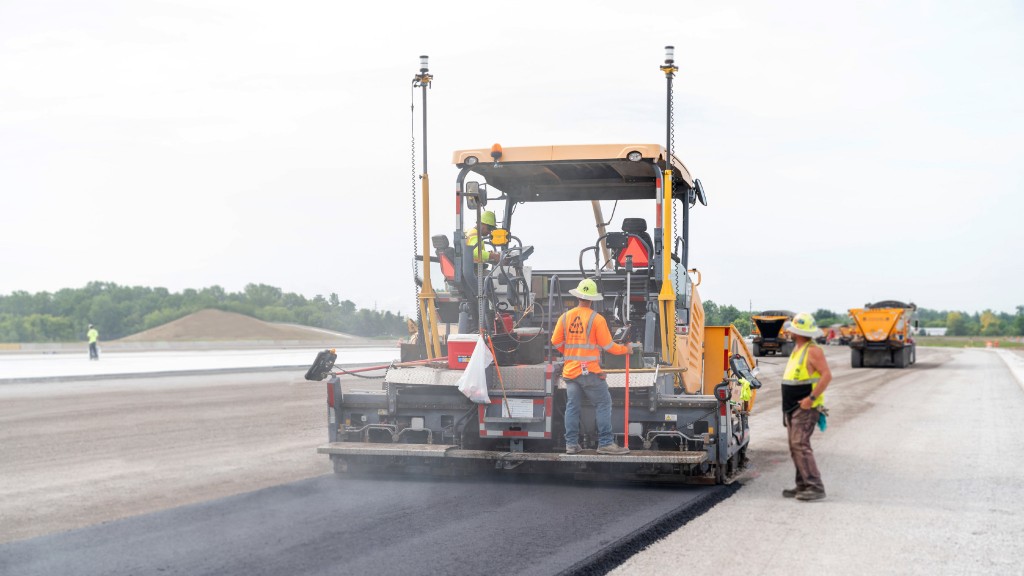 A paver laying asphalt on a road surface.