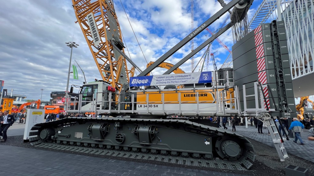 A crawler crane is parked at a trade show
