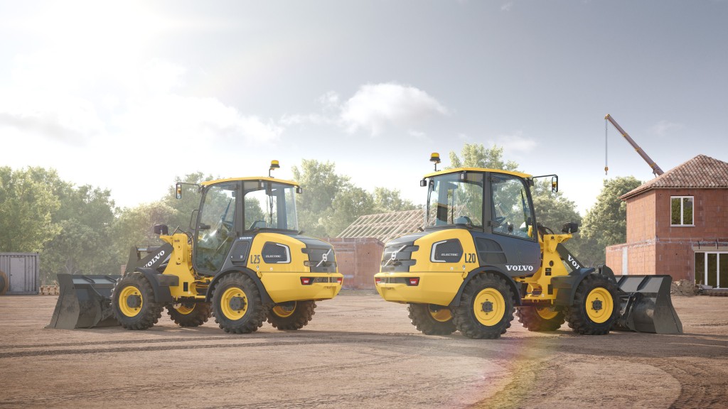 Two electric wheel loaders on a dirt pad