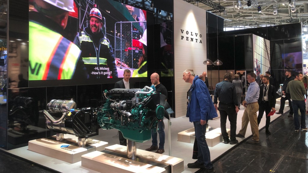 People walk around a trade show exhibit