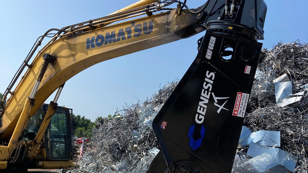 An excavator operates in a scrap yard