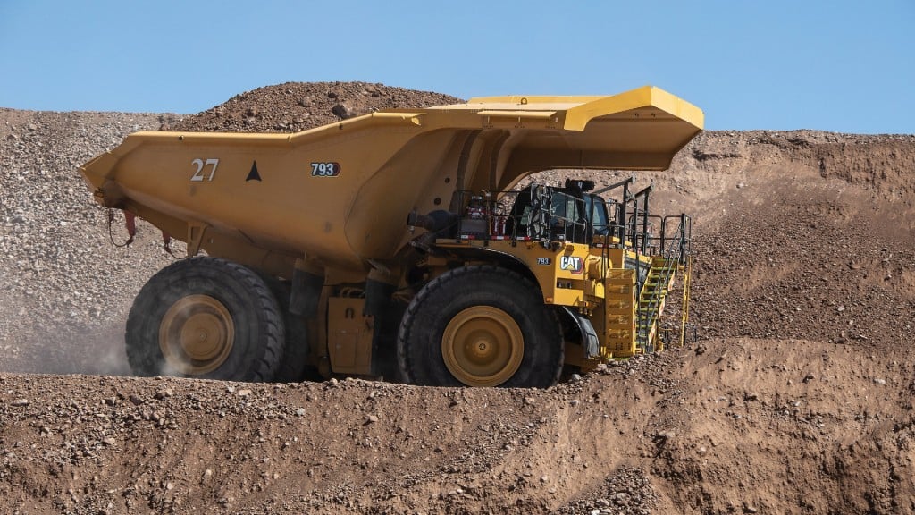 A mining truck drives along a haul road.