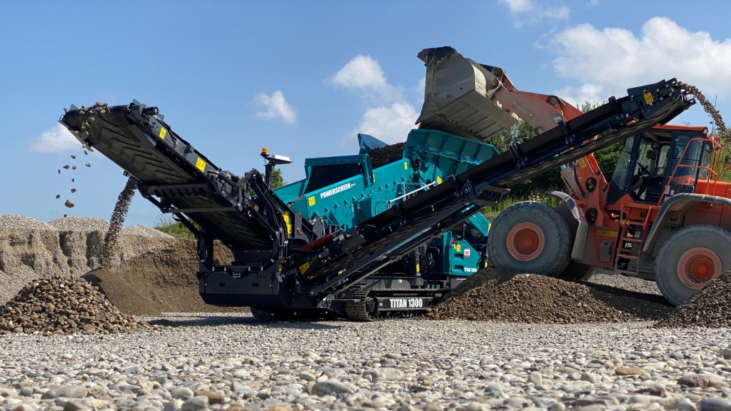 A crusher is fed by a wheel loader in a gravel pit