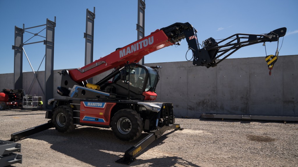 A telehandler with outriggers down in a construction site