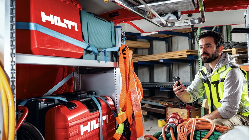 Somebody uses their phone to locate tools in a work van