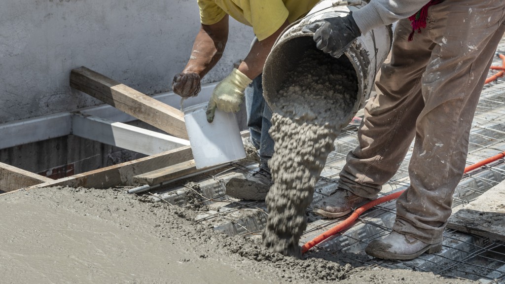 People spread out concrete on a job site