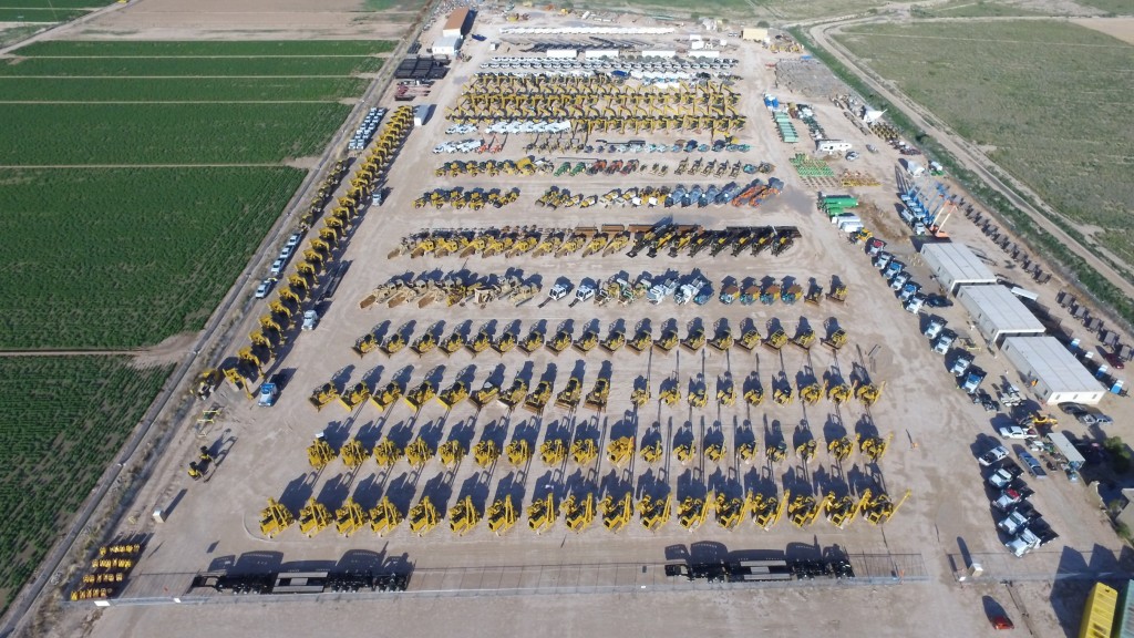 Aerial view of an auction site filled with equipment