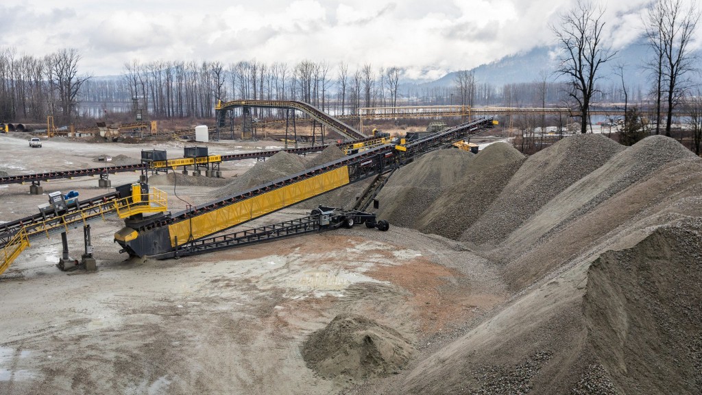 A conveyor moves gravel onto a large pile