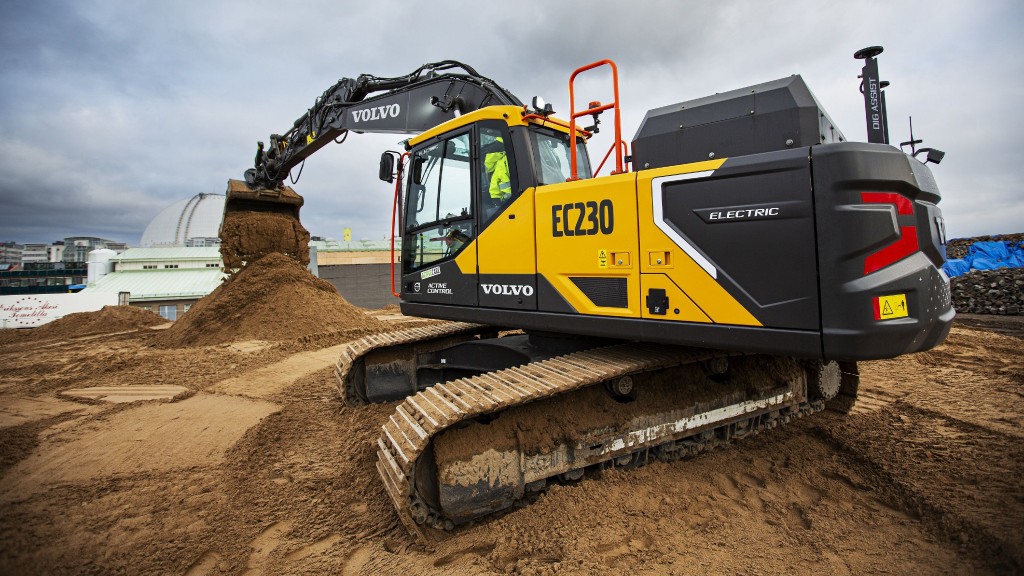 An electric excavator digs up dirt on a job site