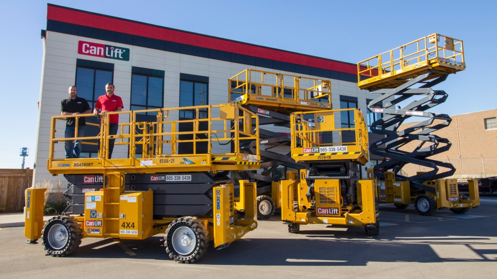 Four scissor lifts are set up outside a CanLift Equipment building