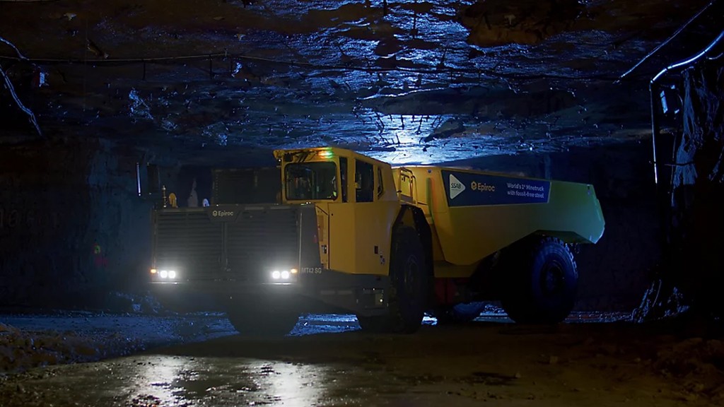 A mine truck turning a corner in an underground cavern