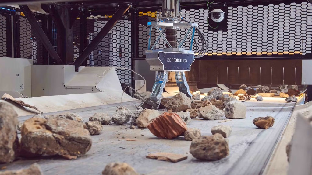 A robotic picker sorts and moves C&D waste on a conveyor