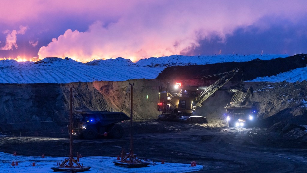 Mining equipment in a pit at dusk