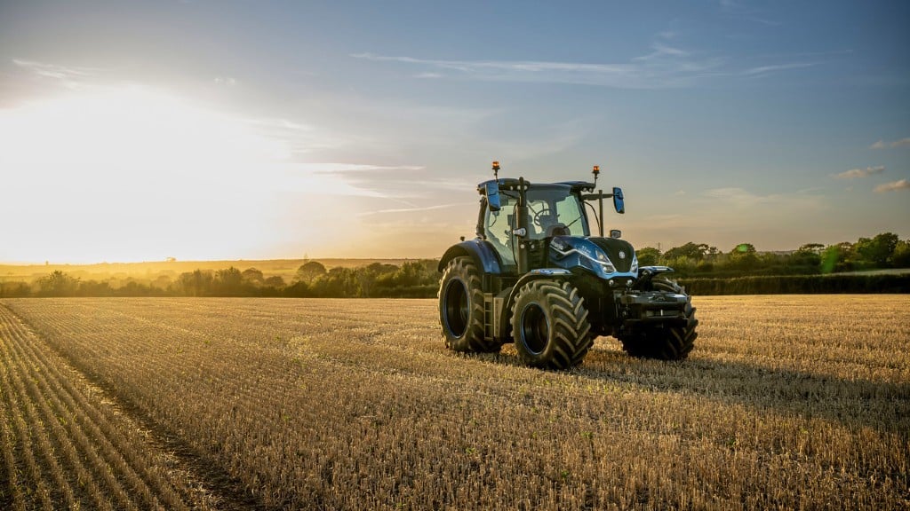 A tractor is parked in the middle of a growing field