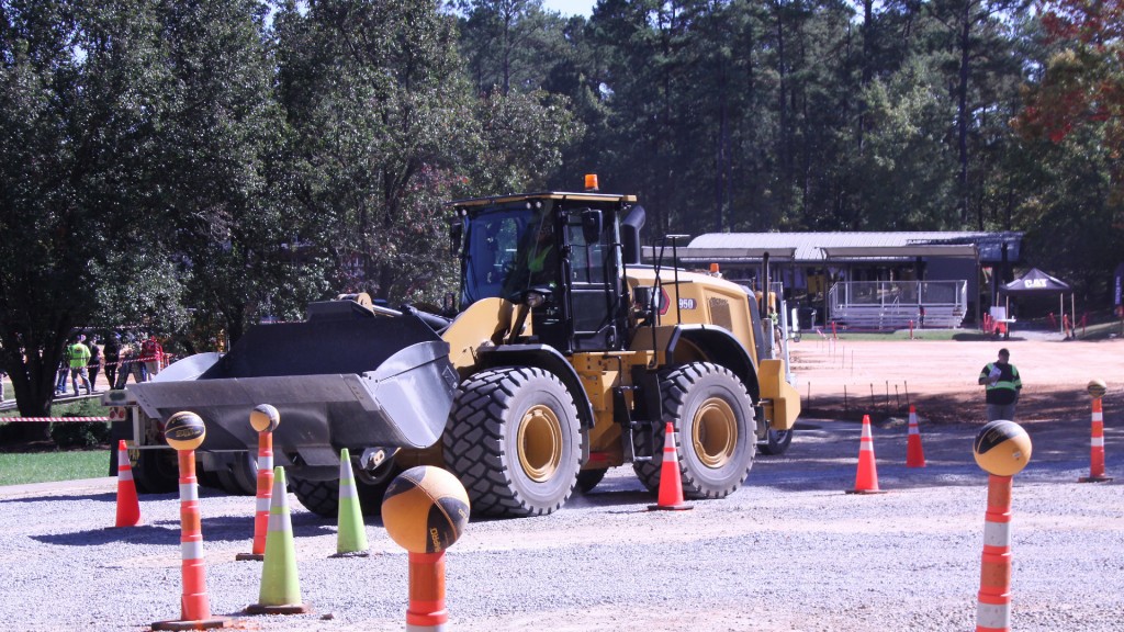 A wheel loader maneuvers through a course made of orange pylons