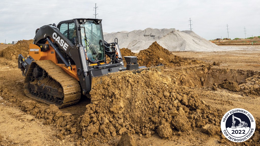 A compact dozer loader pushes a pile of dirt