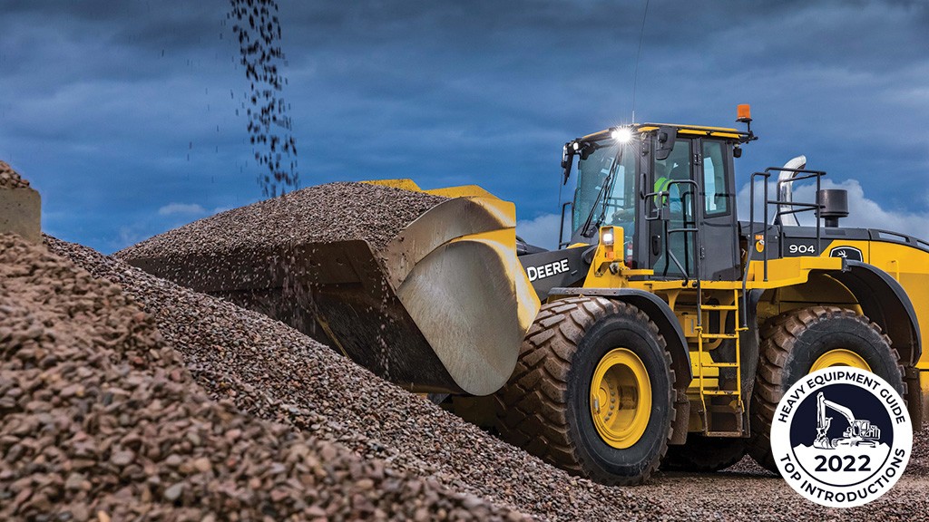 A wheel loader moves a bucket of rocks