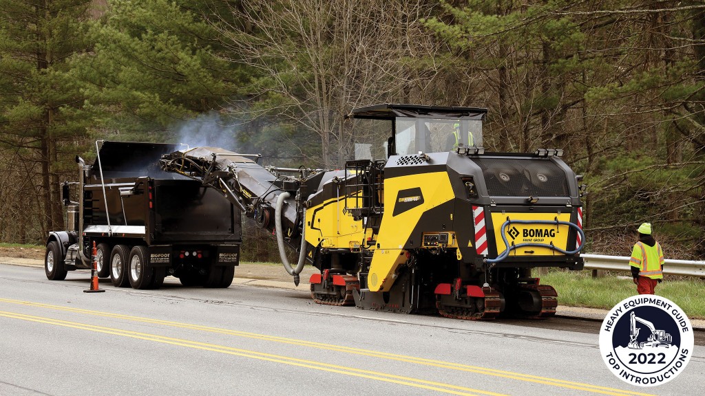A large milling machine removes pavement from a road