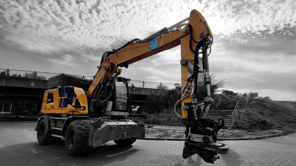 A wheeled excavator parked in a construction site.