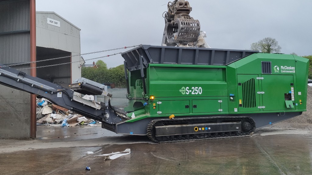 A shredder sits in the lot of a recycling facility