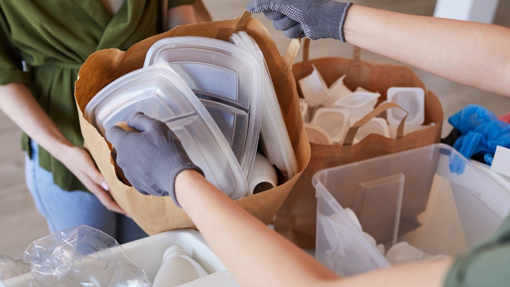 Single-use plastics in a paper bag being handed to another person