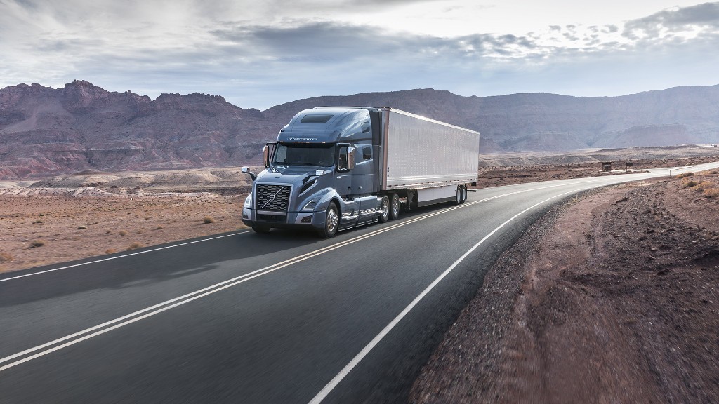 An autonomous truck drives down a road