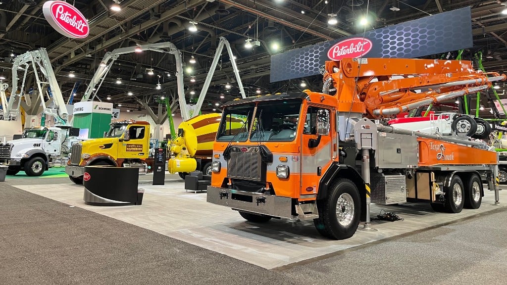 A trade show booth full of vocational trucks