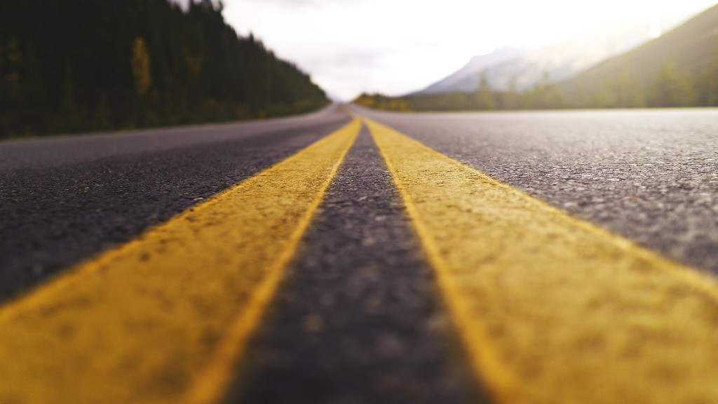 A close-up of double yellow lines on a highway