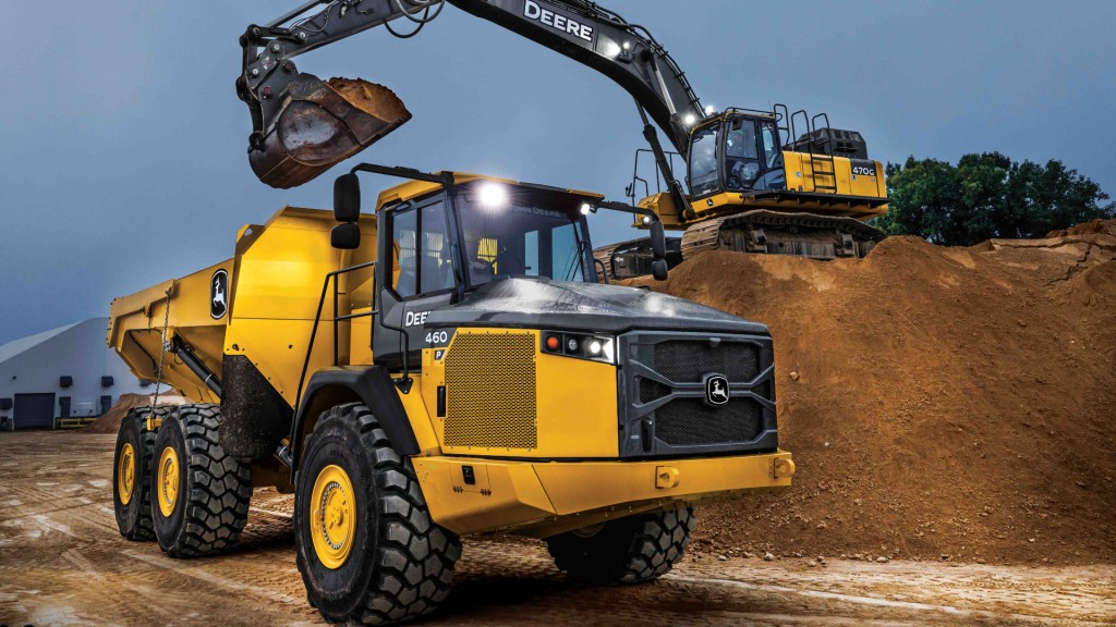 An articulated dump truck being loaded by an excavator.