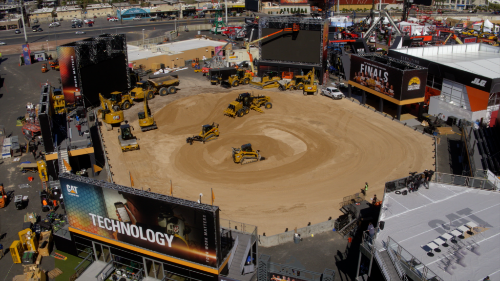 A drone view of an amphitheatre-style outdoor trade show booth with dirt area