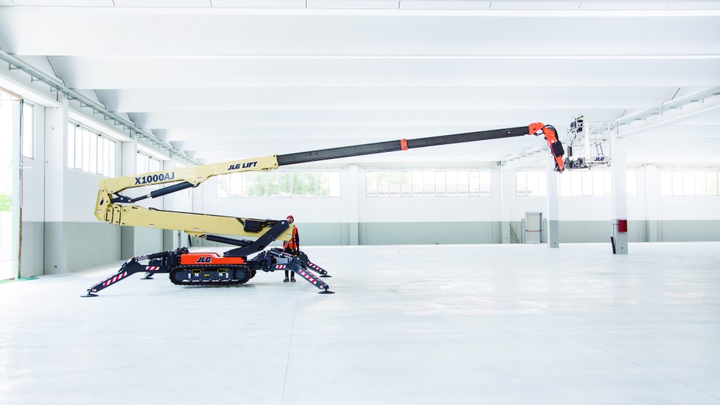 A crawler boom lift is operating inside a large building