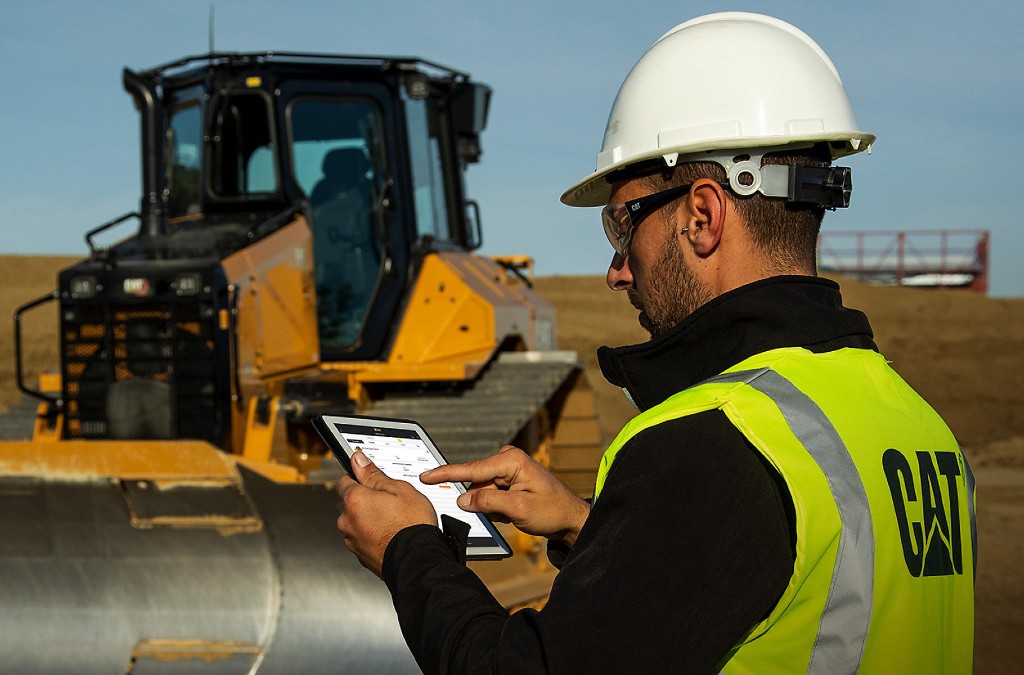 An equipment operator accesses maintenance information on a tablet