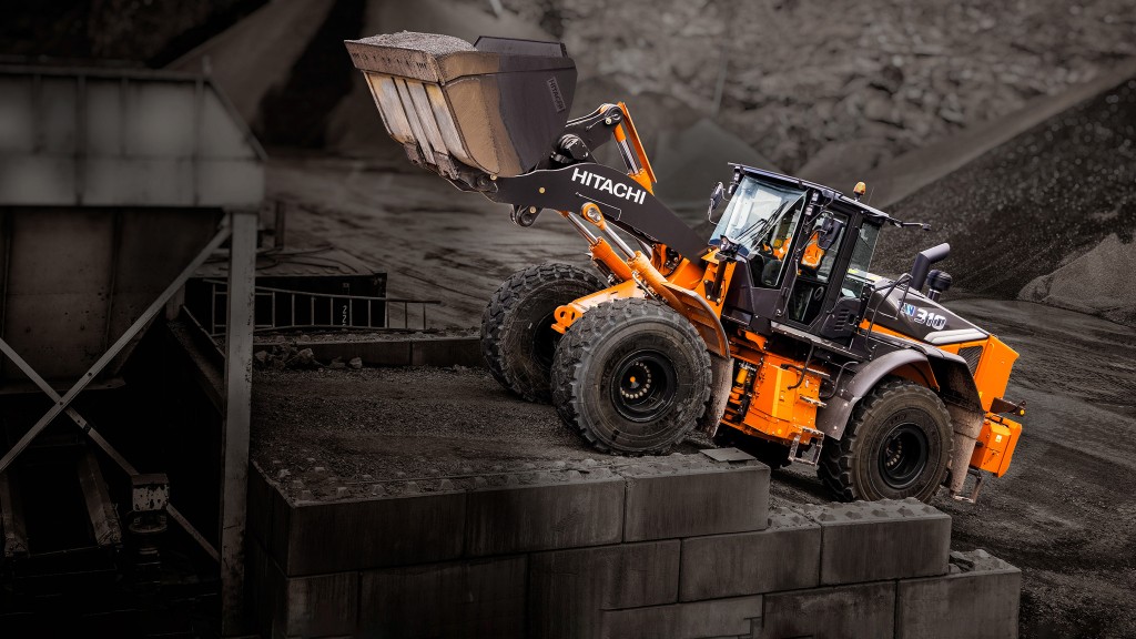 A wheel loader carrying a bucket of material up a slope