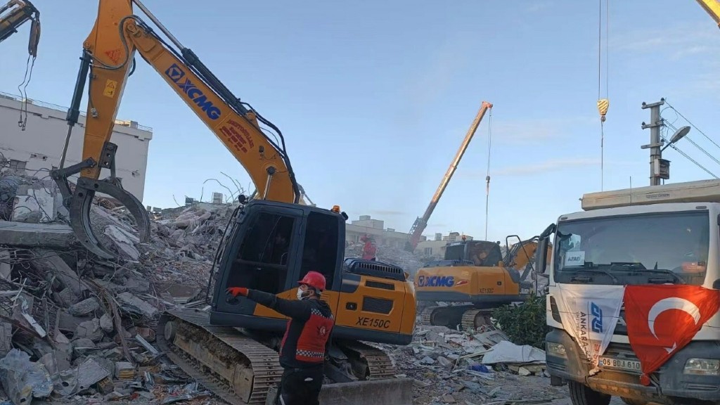 Excavators help with cleanup after an earthquake