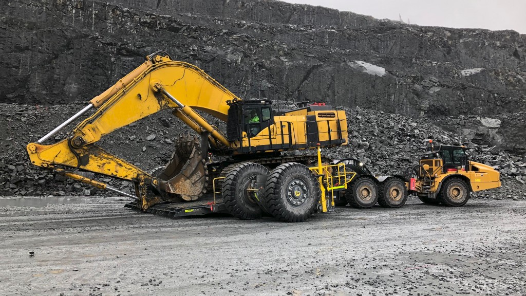 An excavator sits on a transportation system