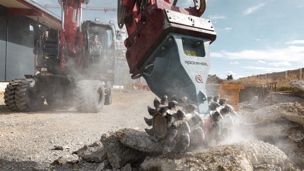 A wheeled excavator uses a RockWheel attachment