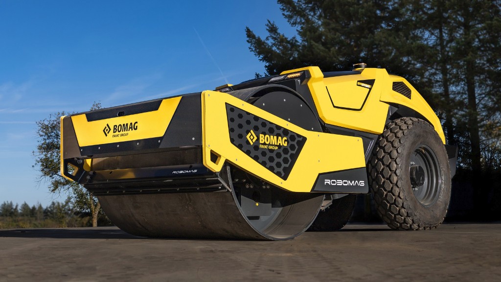 An autonomous concept roller is parked on a job site