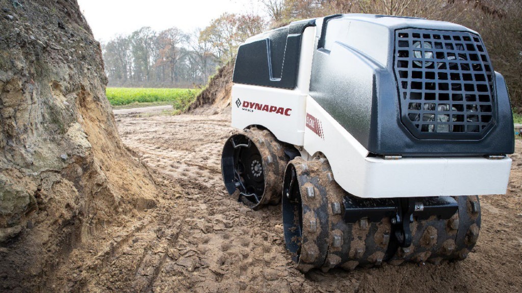 A remote controlled trench roller compacts dirt on a job site