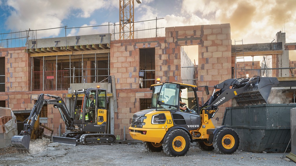 An electric compact excavator and an electric compact wheel loader operate on a job site