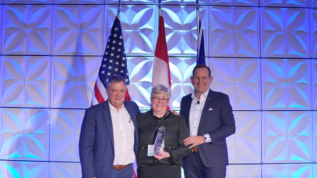 Kelly Sheehan accepts an award on a stage