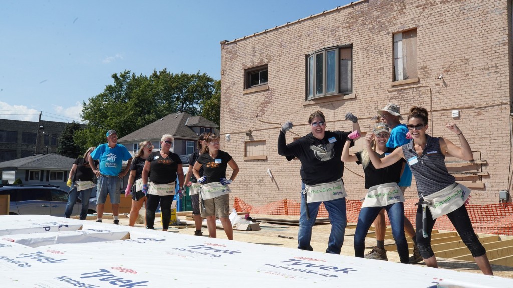 A group of volunteers pose for a photo on a job site