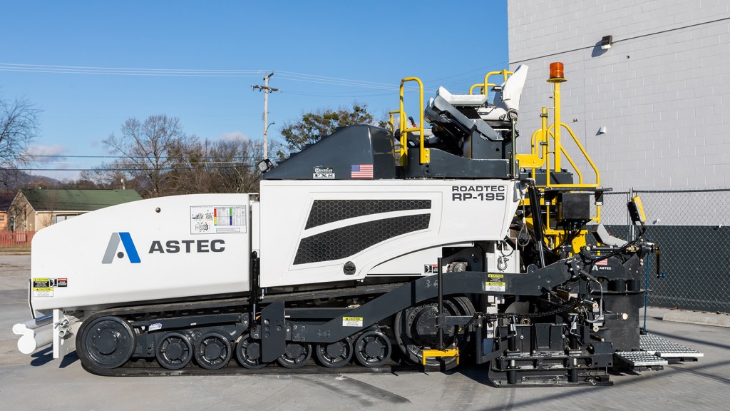 An asphalt paver in a parking lot.