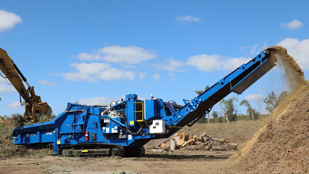 A horizontal grinder working in a job site.