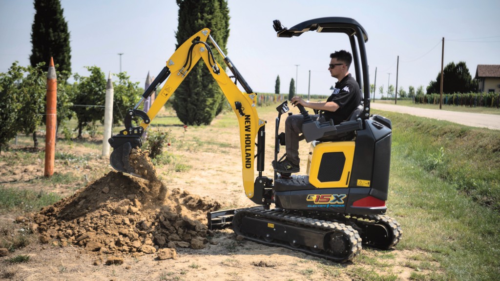 An electric mini excavator digs a hole on a job site