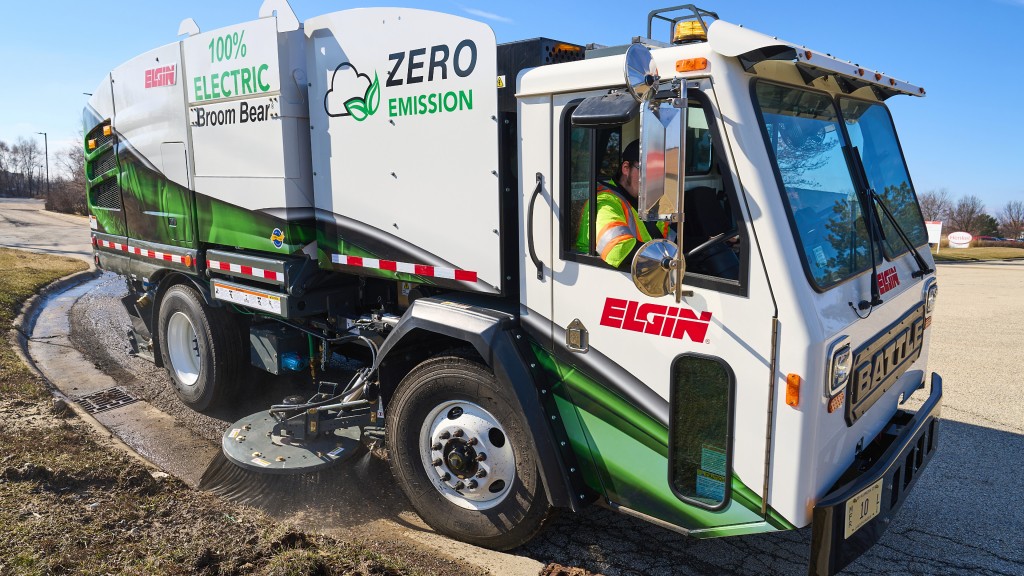 A sweeper sweeps dirt off a curb