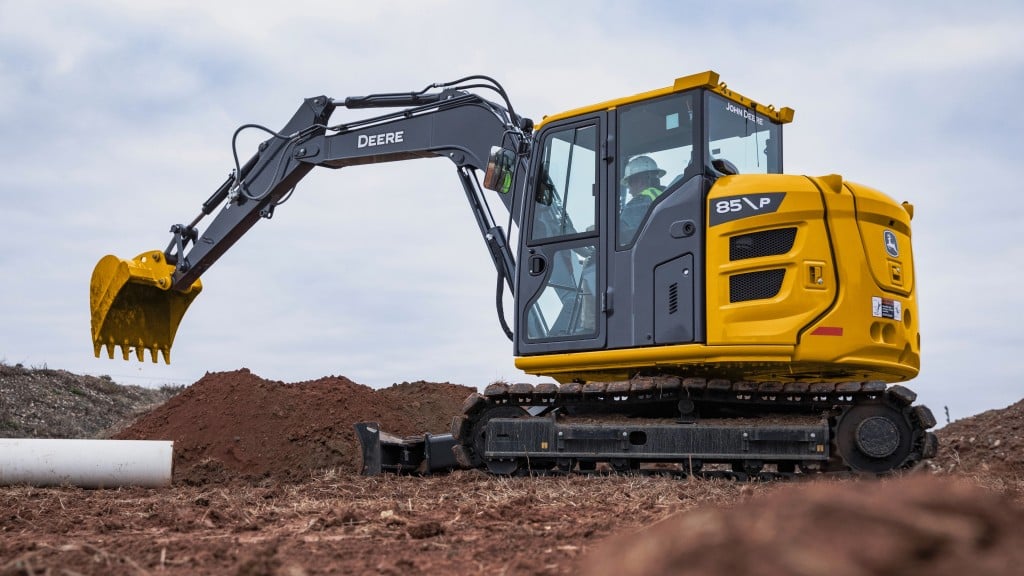 An operator is about to dig a hole with an excavator